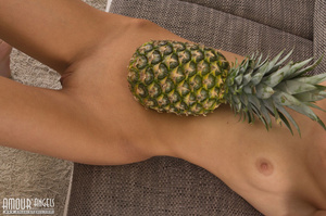 Slender teen girl posing with a big pineapple - Picture 15