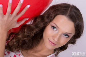 Curly haired brunette playing with her red balloon - XXXonXXX - Pic 1