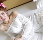 Pink ribbons in hair make this tranny look even seductively