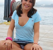 Pretty babe in pigtails pose her foxy body at the beach before she pulls
