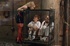 Domme in red fishnets takes control of her caged schoolgirls who are new