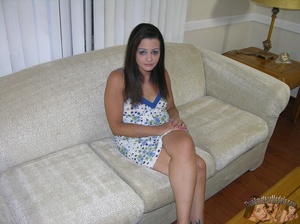Sweet chick sits on a white couch wearing her blue and white dress before she peels it off and shows her petite tits and twat in different poses on a gray bed and brown chair. - Picture 1