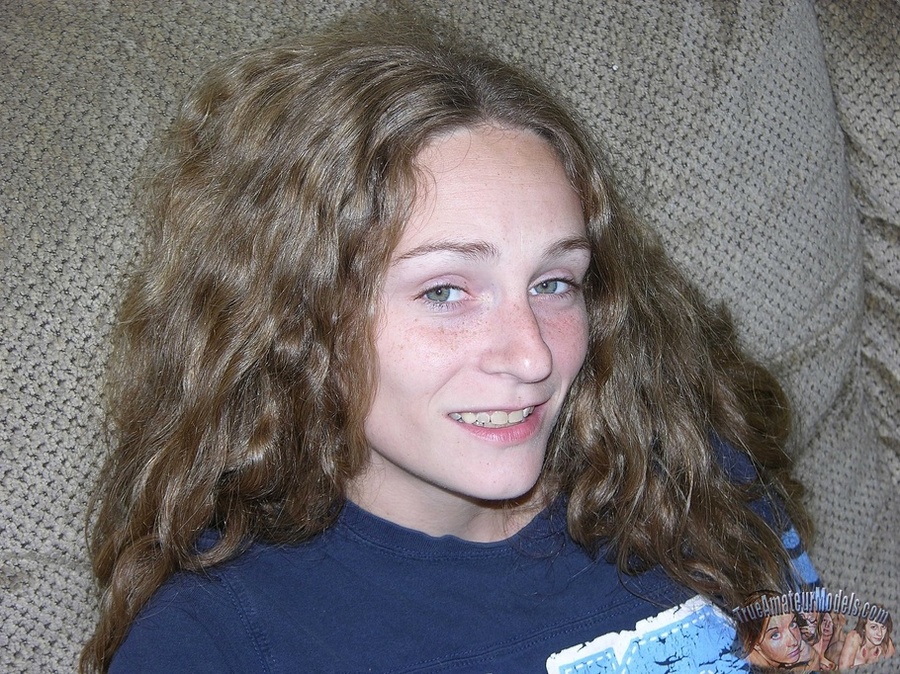 Teen babe with skinny body sits on a gray couch then peels down her jeans skirt and yellow panty and shows her hairy pussy on a gray couch before she takes off her blue shirt and reveals her small tits as she sits naked on a black chair wearing her white rubber shoes. - XXXonXXX - Pic 2