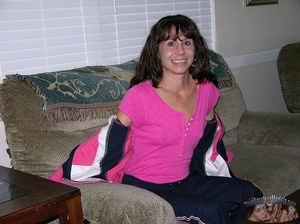 Mature hottie peels off her pink shirt and expose her small boobs and skinny body before she peels down her blue jogging pants and reveals her nasty crack in different poses on gray and brown couches and on a brown bed. - XXXonXXX - Pic 1