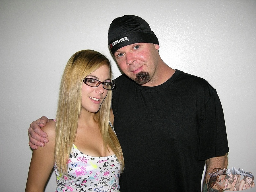 Banging blonde with glasses and stunning body wearing multi-colored shirt, pink shirt, pink and white striped socks and white sneakers holds a huge hard cock then pumps it hard til it spunks on her hand on a gray couch. - XXXonXXX - Pic 2