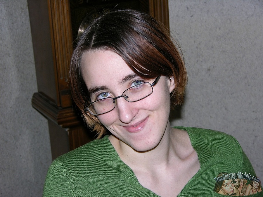 Nerdy chick with glasses slowly peels off her green shirt, black pants, bra and camouflage shorts then displays her skinny body with tiny tits and hairy pussy on a gray couch, brown bed and white tub. - XXXonXXX - Pic 2