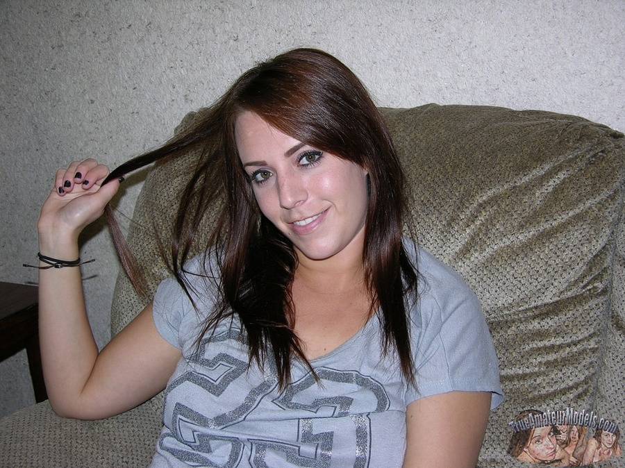 Gorgeous hottie sits on a gray couch and displays her foxy body before she strips off her gray shirt and bares her big hot tits then peels down her jeans skirt and white and gray panty and expose her juicy pussy as she opens her legs wide on a brown bed. - XXXonXXX - Pic 2