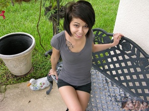 Banging babe pose her luscious body outdoor wearing her sexy gray shirt and black shorts before she goes inside, gets naked and bares her petite tits and shaved pussy in different positions on a gray couch and brown bed. - Picture 1
