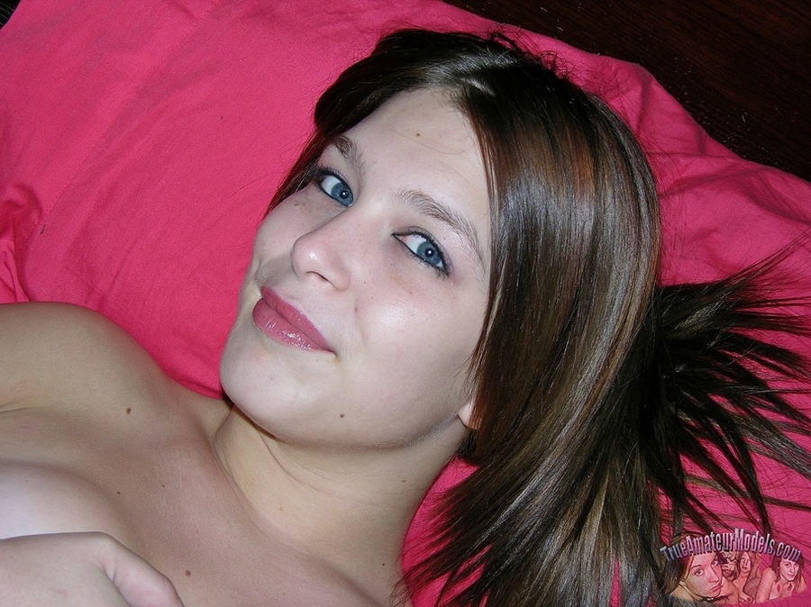 Pretty young chick teases with her luscious pussy as she opens her legs wide on a gray couch wearing her black, pink and white dress and brown boots before she gets naked and reveals her tiny tits in different poses on a brown bed. - XXXonXXX - Pic 12