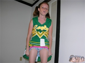 Teen cheerleader in pigtails peels down her pink and blue panty and expose her sweet pussy in different poses on a green seat wearing her green and yellow uniform before she takes it off and lays naked on a violet and white bed. - XXXonXXX - Pic 6