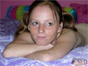Teen cheerleader in pigtails peels down her pink and blue panty and expose her sweet pussy in different poses on a green seat wearing her green and yellow uniform before she takes it off and lays naked on a violet and white bed. - XXXonXXX - Pic 15
