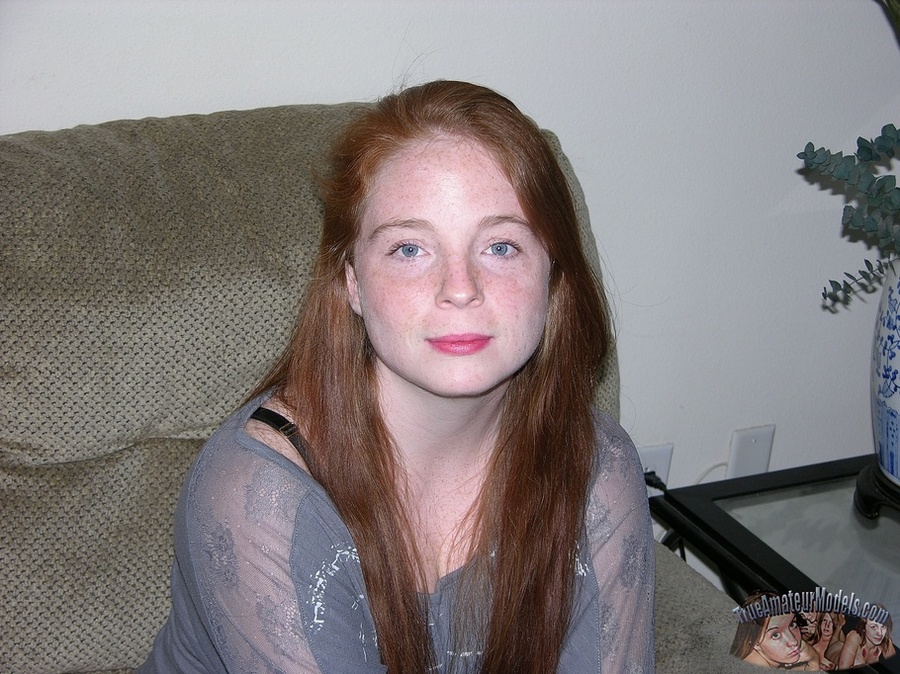 Cute redhead peels off her gray see through blouse and black bra and shows her big juggs then strips down her jeans and black panty and reveals her hot crack as she pose naked on a gray couch, brown bed and white tub. - XXXonXXX - Pic 1