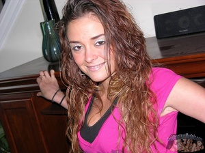 Curly redhead takes off her pink shirt then displays her banging body before she peels off her red and black bra and reveals her juicy tits then strips down her jeans and black panty and seduces with her alluring pussy in different positions on a gray couch, brown chair and bed. - XXXonXXX - Pic 2