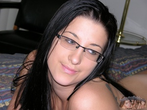 Pretty chick with glasses pose her banging body then strips down her gray pants and thong then reveals her luscious twat on a black couch before she takes off her gray shirt and expose juicy boobs as she sits naked on a black chair wearing her pink and black socks. - XXXonXXX - Pic 8
