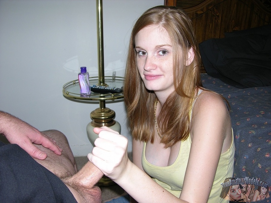 Sexy young redhead with smoking hot body gets on her knees wearing her hot yellow shirt and jeans then holds a bald dude's dick tight then sucks it on a black chair. - XXXonXXX - Pic 12