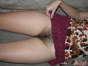 Indian hottie wearing brown and white blouse expose her hairy twat under her maroon and black skirt on a gray couch before she gets naked and bares her small tits and skinny body on a wooden chair and gray bed. - Picture 4