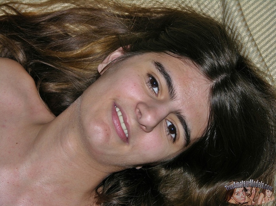 Skinny babe pulls down her jeans and show her clean shaved pussy before she takes off her green and white shirt and reveals her tiny boobs as she lays naked on a brown couch, white and gray striped bed and black chair. - XXXonXXX - Pic 10