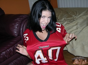 Foxy chick folds her hot body on a black chair and expose her nasty holes wearing her red jersey shirt before she gets naked and strech out her twat in different poses on a purple bed and in a kitchen. - XXXonXXX - Pic 2
