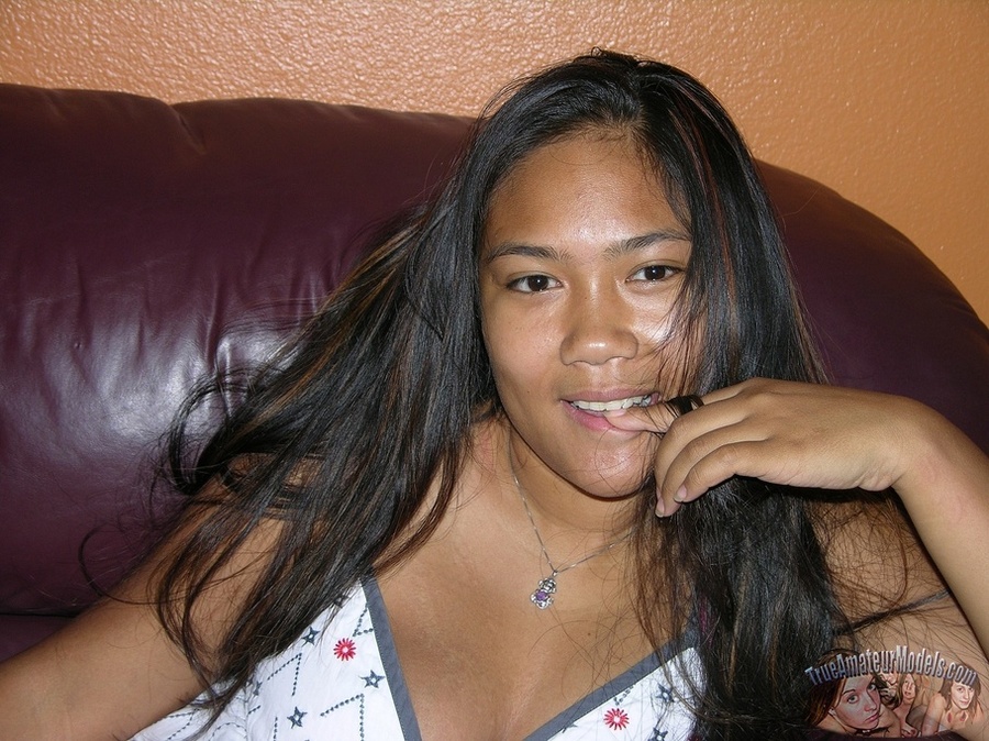 Steaming hot Asian pose her hot body on a brown couch before she peels down her green and gray striped panty and allures with her indulging pussy then strips off her white blouse and pose naked on a violet bed. - XXXonXXX - Pic 2