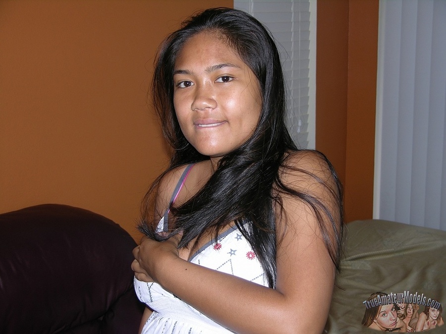 Steaming hot Asian pose her hot body on a brown couch before she peels down her green and gray striped panty and allures with her indulging pussy then strips off her white blouse and pose naked on a violet bed. - XXXonXXX - Pic 3