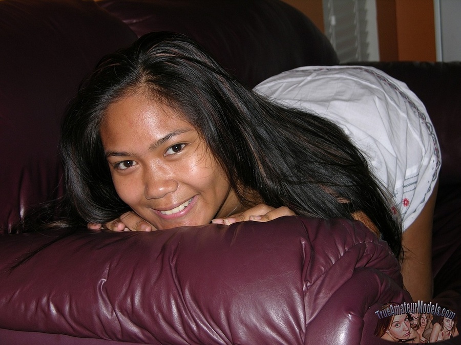 Steaming hot Asian pose her hot body on a brown couch before she peels down her green and gray striped panty and allures with her indulging pussy then strips off her white blouse and pose naked on a violet bed. - XXXonXXX - Pic 8