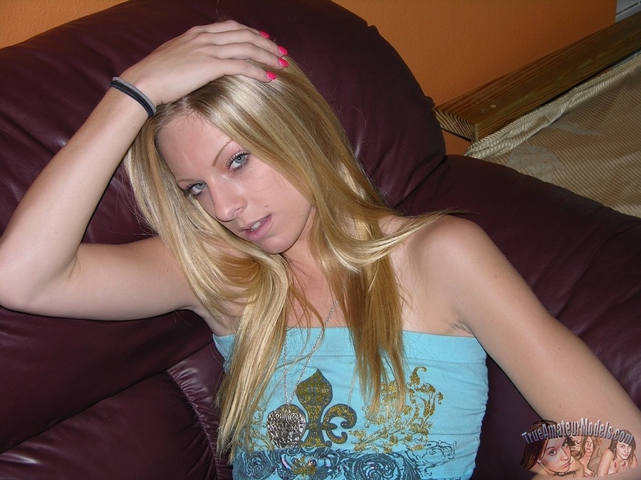 Gorgeous blonde hottie displays her hot body on a brown couch then peels off her sexy tube shirt, jeans and black panty and bares her small tits and luscious pussy in different positions on a gray and white bed. - XXXonXXX - Pic 2