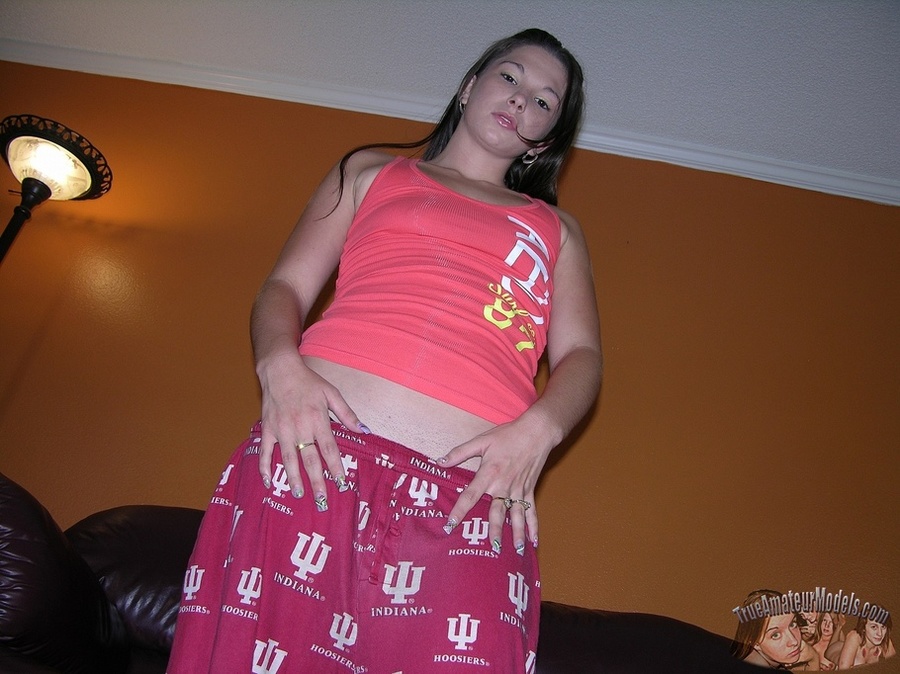 Gorgeous babe displays her banging body then takes off her pink and white skirt and teases with her lusty pussy on a brown couch before she takes off her pink shirt and expose her tiny tits in different poses on a black chair and on a gray and white bed. - XXXonXXX - Pic 3