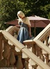 Blonde gal uses crazy machine outdoors by the poolside