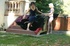 Blonde gal uses crazy machine outdoors by the poolside