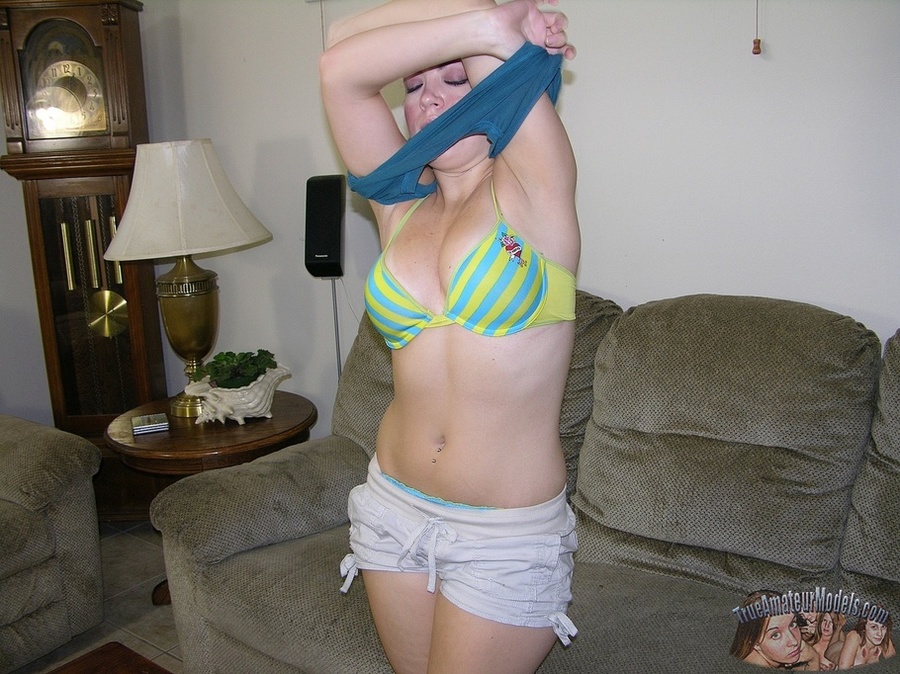 Gorgeous hottie slowly peels off her blue shirt and green and yellow bra and shows her lusty tits before she pulls down her jeans shorts and blue laced panty and reveals her indulging pussy in different positions on a gray couch and white bed. - XXXonXXX - Pic 3