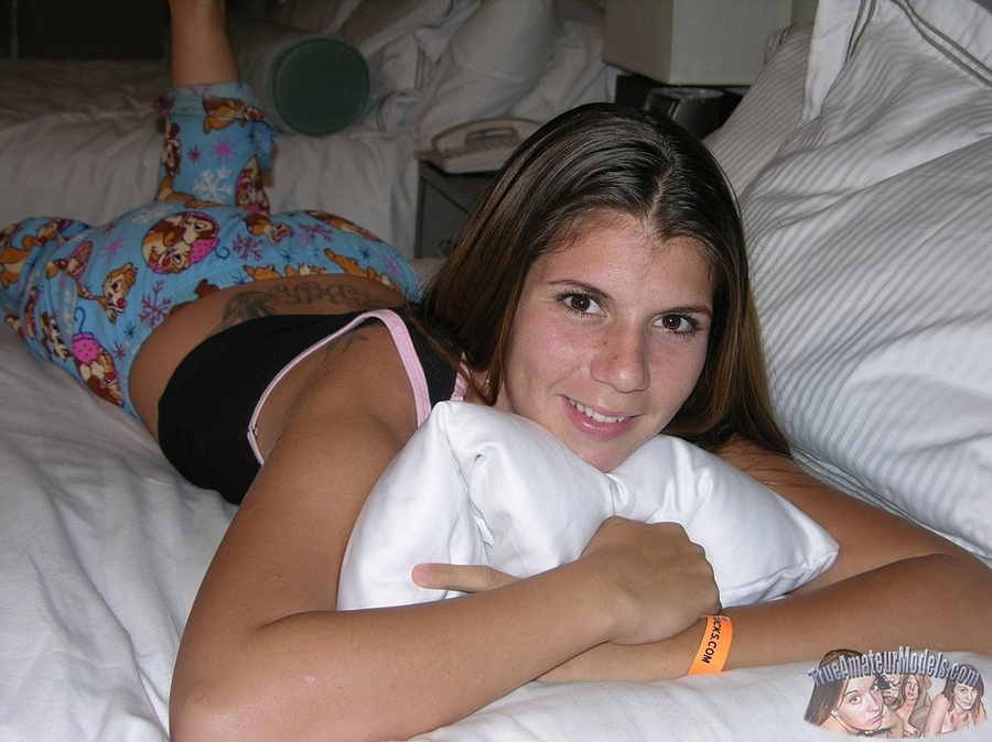 Teen hottie pose her slim body as she lays on a white bed then peels down her multi-colored pajama pants and reveals her hairy pussy before she takes off her black shirt and expose her tiny tits and huge ass in different poses. - XXXonXXX - Pic 3
