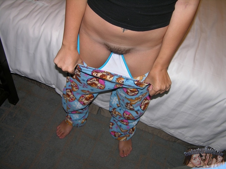Teen hottie pose her slim body as she lays on a white bed then peels down her multi-colored pajama pants and reveals her hairy pussy before she takes off her black shirt and expose her tiny tits and huge ass in different poses. - XXXonXXX - Pic 5