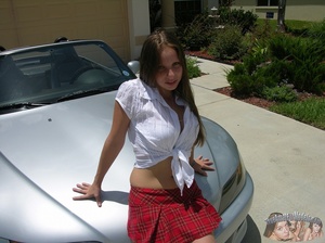Cute school girl gets naughty as she pose her foxy body on a hood of a silver car wearing her white blouse, red checkered skirt and black high heels before she goes inside, lays on a gray couch and expose her pussy then strips off her clothes and shows her sweet boobs as she pose naked on a brown stairway and on a white bed. - Picture 3