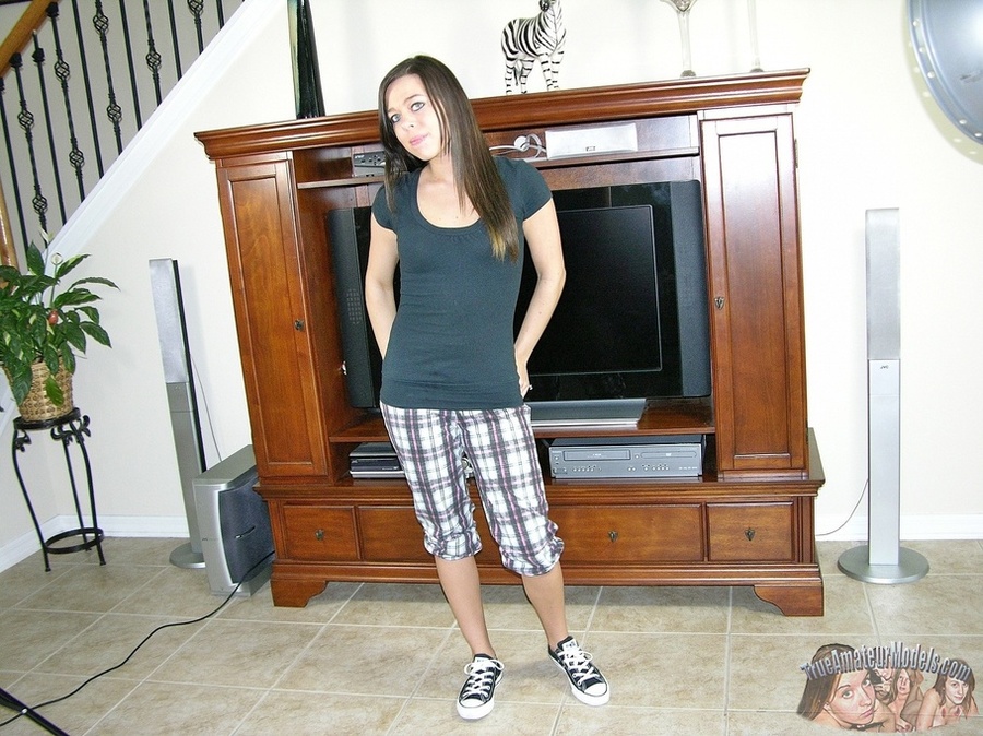 Gorgeous teen pose her foxy body in black shirt, black and white checkered shorts and shoes before she shows her lusty butt while she gets naked then reveals her small tits and erotic pussy in different poses on a gray bed. - XXXonXXX - Pic 2
