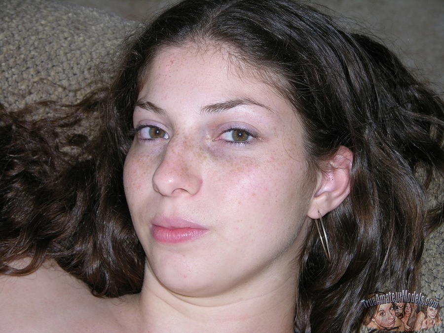 Curly teen brunette pose her skinny body then peels off her brown shirt and reveals her tiny tits before she drops down her jeans and expose her lusty crack as she lays naked on a gray couch and white bed. - XXXonXXX - Pic 8