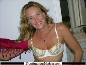 Pretty blonde peels off her pink shirt and blue skirt then displays her banging body in white lingerie before she expose her hot tits and stimulating pussy in different positions on a multi-colored bed. - XXXonXXX - Pic 3