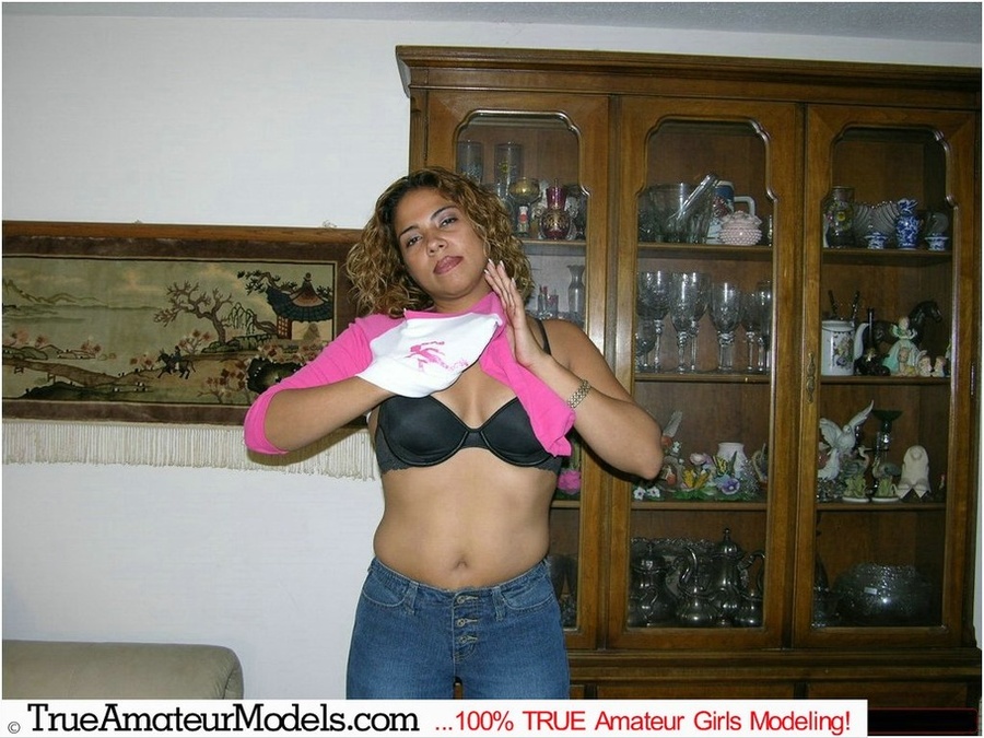 Gorgeous chick with curly hair displays her stunning body before she slowly strips off her pink and white shirt, jeans and black underwear and bares her tiny tits and ravishing pussy in different poses on a white couch and gray bed before she grabs a huge cock then sucks it on a white bed. - XXXonXXX - Pic 4