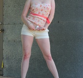 Gorgeous redhead pulls down her white shorts and displays her juicy butt