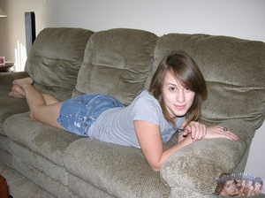 Pretty chick lays prone on a gray couch then peels off her blue panty and teases with her indulging pussy wearing her gray shirt and jeans skirt before she gets naked and reveals her skinny body with petite tits on a wooden couch and white bed. - XXXonXXX - Pic 2