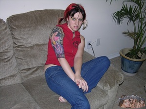 Tattooed and pierced hottie peels down her jeans and shows her sweet crack on a gray couch then takes off her red shirt and bares her small tits in different poses on a gray couch. - XXXonXXX - Pic 2