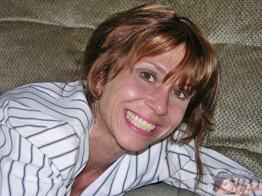 Hot MILF spreads her legs wide on a gray couch and expose her nasty pussy wearing her white office blouse with black stripes, black undershirt, skirt and high heels before she gets naked and reveals her hot boobs and sexy body. - XXXonXXX - Pic 1