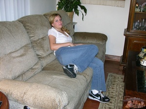 Teen chick sits on a gray couch and displays her hot body wearing her white blouse, jeans and black and white rubber shoes before she takes them off and shows her sexy butt then strips down her black and pink panty and shows her hot crack before sucks a huge cock then gets doggy fucked on a brown bed. - XXXonXXX - Pic 2