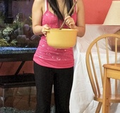 Petite babe in pink top and black pants drops cooking to show sexy ass