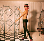 Elegant 50's lady with a hat displays her marvelous body