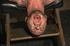 Muscled dude in leather mask roped to the cell grating gets blown and