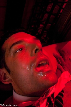 In a room shrouded in red light, a busin - XXX Dessert - Picture 17