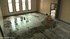 While scrubbing floors in an empty room, a fitted leather hood is placed