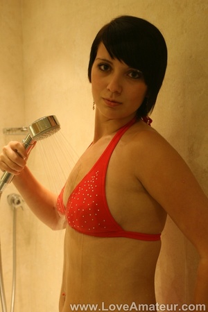 All natural brunette in bikini rubs her tits against the shower door - Picture 4