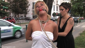 Ball-gagged blonde in a sexy white ensem - Picture 6