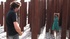 Brunette in a striking green dress is led around like a dog before she’s